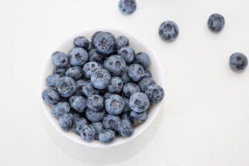 Blueberry is tasty, healthy and delicious fruits. Fresh blueberries  in white bowl. Wild blueberries in white plate on white background.