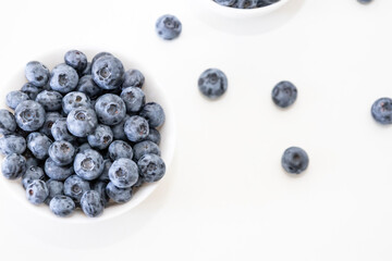 Blueberry is tasty, healthy and delicious fruits. Fresh blueberries  in white bowl. Wild blueberries in white plate on white background.