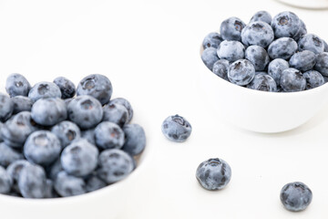 Blueberry is tasty, healthy and delicious fruits. Fresh blueberries  in white bowl. Wild blueberries in white plates on white background.