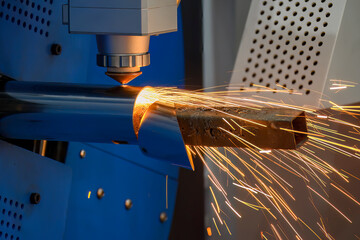 Close up scene the fiber laser cutting machine cut the stainless steel tube control by CNC program.