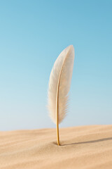 Soft feather standing upright in smooth sand under clear blue sky, evoking calm and peaceful desert solitude