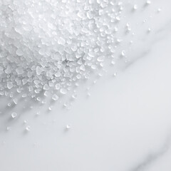 Coarse white salt crystals scattered on smooth white surface with soft natural lighting creating gentle shadows
