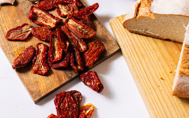Sun-Dried Tomatoes on Wooden Board with Fresh Bread