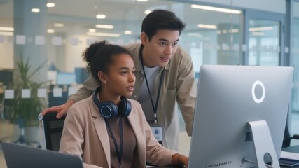 Diverse Professionals Collaborating on Computer in Modern Office