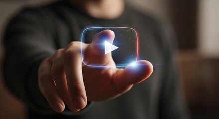 Finger pressing a glowing play button icon on a digital interface.