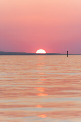 orange and red sunset over Lake Constance  in Höchst Vorarlberg Austria on the so called Rohrspitz...