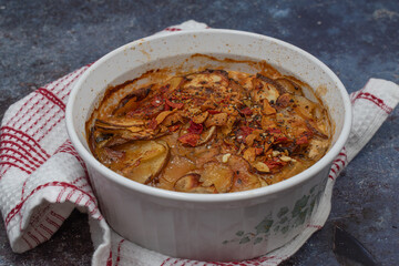 Potato mushroom casserole, baked, served in baking dish