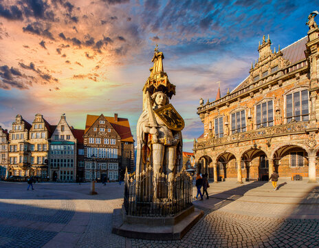 The famous Bremen Roland statue on the marketplace in Bremen, surrounded by ornate historic buildings at sunset