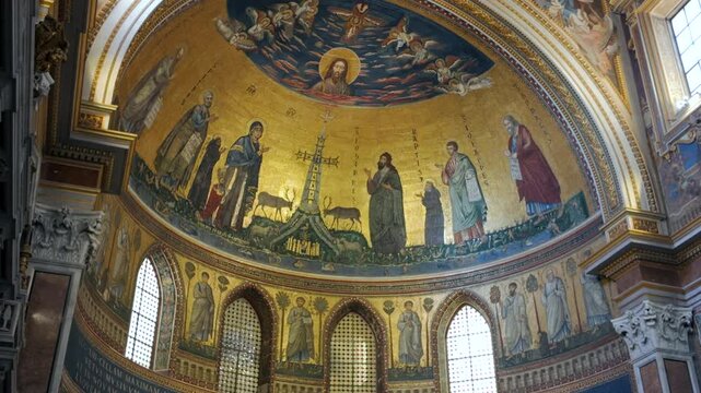 Close-up of apse mosaics in Basilica of St. John Lateran depicting Christ, saints, and symbolic lambs surrounded by golden background and arches