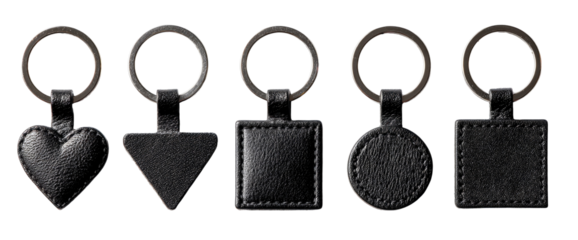 Five black leather keychains with various shapes
