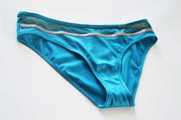 Women's turquoise swimsuit bikini panties on white background. Beachwear.