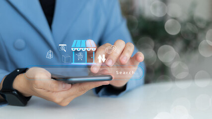 Businessman using smartphone with online shopping search bar and e-commerce icons, digital...