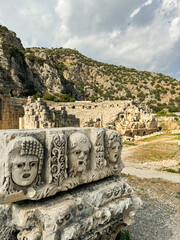 Ancient stone carvings and ruins in a historical landscape
