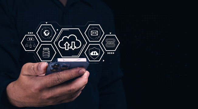 Person using a smartphone with digital cloud technology icons floating above it. - Powered by Adobe