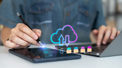 Person using tablet stylus and laptop with cloud computing icon, secure login interface, and file...