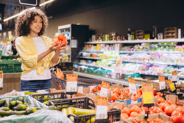 Woman Choosing Tomatoes in Supermarket Produce Section