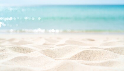 A serene beach scene featuring soft, golden sand and glistening turquoise water, evoking a sense of calm and relaxation.