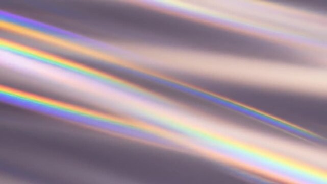Rainbow light diffraction beams across a soft gradient surface creating a colorful optical background animation