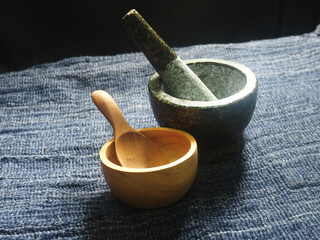 mortar and pestle on wooden table, closeup