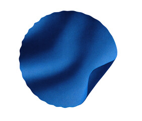 A deep blue, circular, draped fabric shape against a black background.  The fabric's texture is smooth with subtle, undulating folds, creating a sense of movement.  