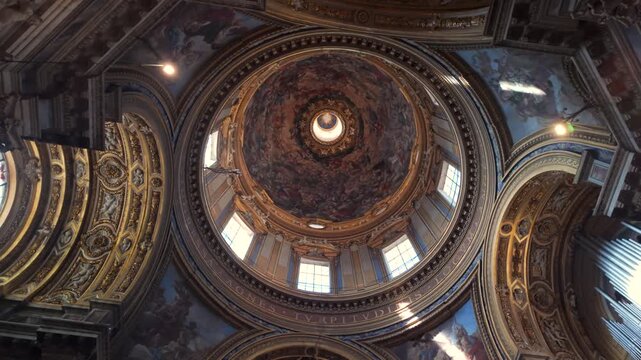 Ornate baroque dome interior of Sant&rsquo;Agnese in Agone with detailed frescoes and golden architectural elements