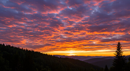 Obraz premium Radiant skies over a tranquil mountain landscape, captured in a breathtaking sunset where fiery orange hues meet the cool tranquility of the purple clouds creating a magical panorama