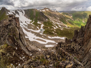 Wide mountain valley with steep cliffs.