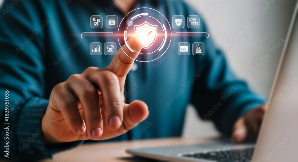 Poster person touching a digital shield icon with futuristic interface, symbolizing cybersecurity and data 