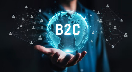 Businessman holding a glowing digital globe with b2c text, representing business to consumer connections and global network in a futuristic technology concept