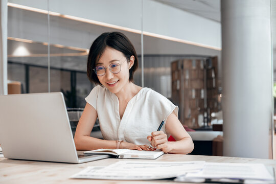 Middle-age Asian woman using laptop computer for business studying, watch online virtual webinar training meeting,video call. Eastern mature 40s years businesswoman work online in office. Copy space