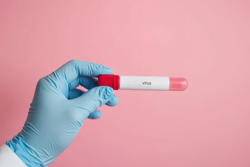 Cropped unrecognizable doctor's hand showing a blood test of virus against a pink background
