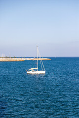 A small sailing ship on the sea at the horizon	