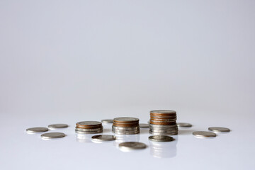 Stacked coins with calculator and pen for financial planning