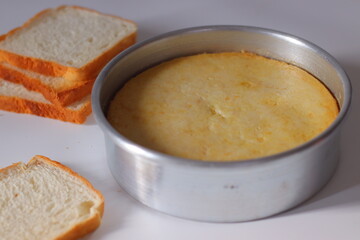 Caramel bread pudding freshly baked and still in the pan, showcasing its soft, custardy texture before demolding