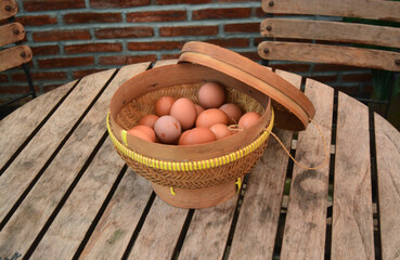 chicken eggs in a traditional bamboo basket