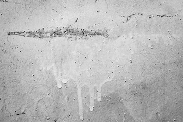 A textured, distressed wall with subtle imperfections and faint markings, perfect for adding a raw,...