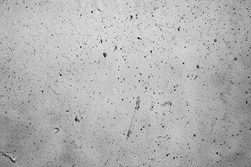 A textured, distressed wall with subtle imperfections and faint markings, perfect for adding a raw,...