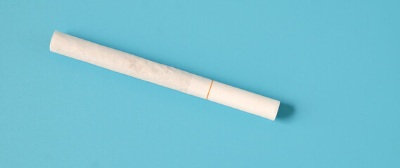 white cigarette on color background, closeup.