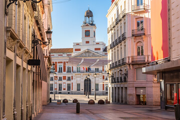View of the Puerta del Sol clock tower from Callao Street in central Madrid, Spain.