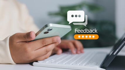Customer satisfaction, online review, and business service evaluation. Close-up of person holding smartphone with feedback and five-star rating icon.