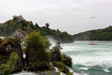 An impressive panoramic view of the Rhine river near the Rhine Falls, with a wide area of foamy...