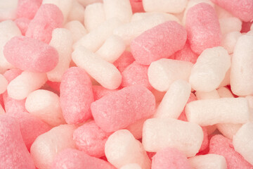 Pink and white box filler as a background. Top view.