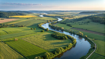 Aerial view of river landscape with green fields and forests for travel and nature photography use