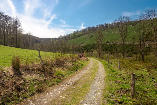 Rural landscape with fields, a dirt road and hlls in Herbeumont, Belgium