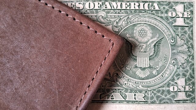 Leather wallet and dollar bills