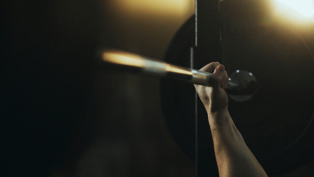 Bodybuilder lifting weights in gym during intense workout