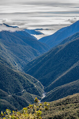 Peruvian Andes  valley with fog and dramatic sky, Manu road, Cusco, Peru
