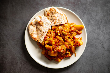 Grilled chicken with vegetable ratatouille on plate.