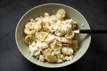 Delicious bowl of banana and cottage cheese breakfast with oats.