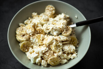 Healthy breakfast bowl with bananas, cottage cheese, and oats.